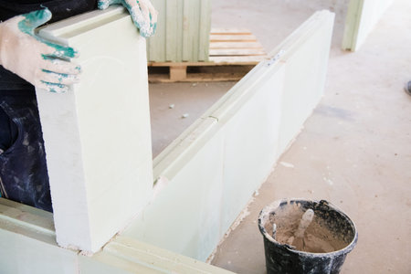 Unfinished construction empty room. Walls from lightweight aggregate concrete blocks with empty doorframesの写真素材