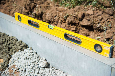 The process of construction of the sidewalk, the installation of a vertical curbの写真素材
