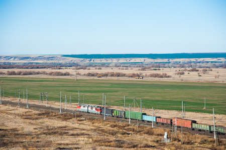 Freight train crossing through railroad station. Railway freight cars and tank carsの写真素材