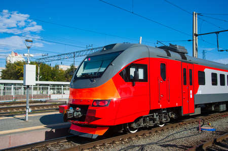 Red train in modern railway central stationの写真素材