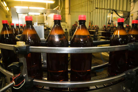 Food industry. Plastic bottles with a carbonated drink on the conveyorの写真素材