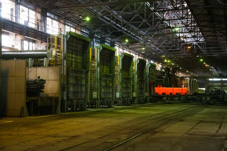 Metal structures and buildings of the old metallurgical plant inside and outside. The process of melting metal. Steelworker at work. Products of the metallurgical enterprise.の写真素材