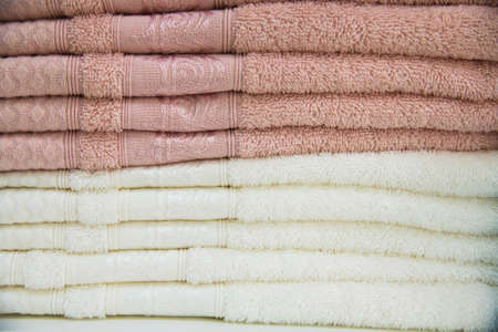 Colorful towels on the shelves in the storeの写真素材