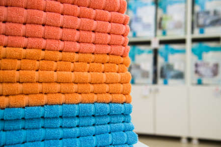Colorful towels on the shelves in the storeの写真素材