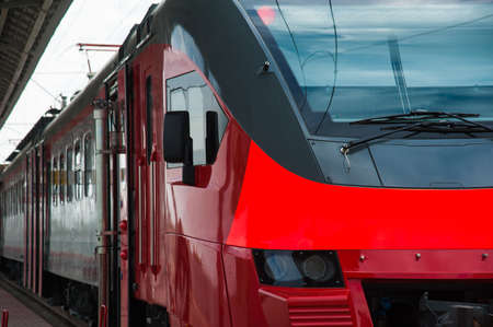 Red train in modern railway central stationの写真素材
