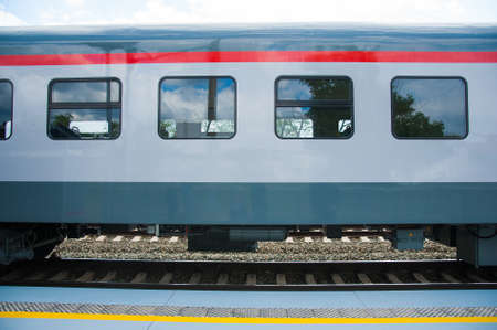 Red train in modern railway central stationの写真素材