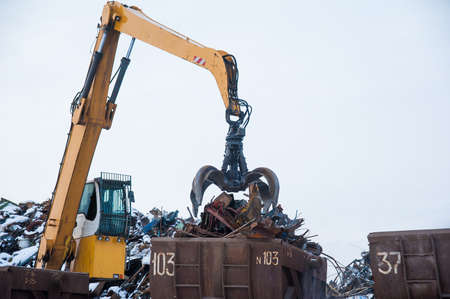 Scrap metal recycling plant and crane-loading scrap in a trainの写真素材