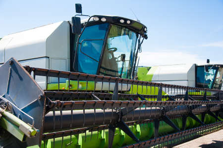 Combine harvesters, in a wheat field ready for harvestの写真素材