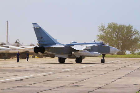 Military fighter jet at the airfield. Service before flightの写真素材