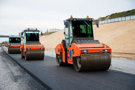 The road rollers working on the new road construction siteの写真素材