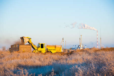 Bulldozer removes a wild dump near the city. Ecologyの写真素材