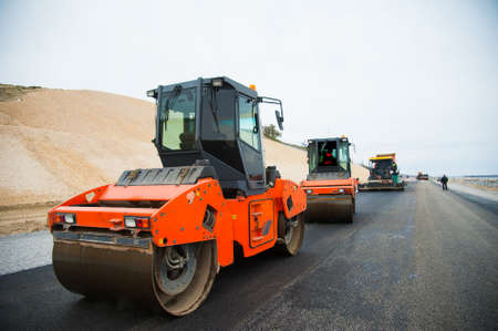 The road rollers working on the new road construction siteの写真素材