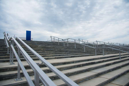 Outdoor concrete staircase with stainless steel handrail. Fall protectionの写真素材