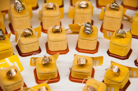 Golden accessories in the display window of a jewelery storeの写真素材