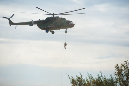 Military helicopter flying during exercise performing a military demonstrationの写真素材