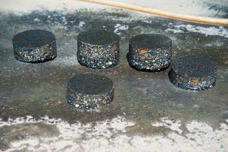 Checking the quality of asphalt by taking samples and measuring the thickness of asphalt. Construction. Repair of roadsの写真素材