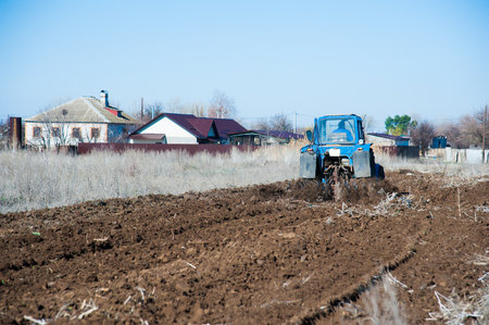 Tractor plowing fields - preparing land for sowingの写真素材