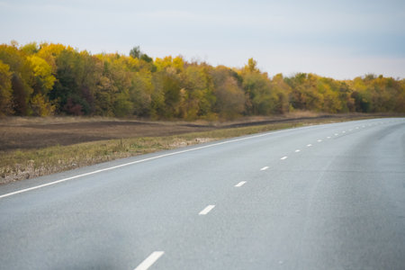 The amount of traffic. Intercity highway in cloudy autumn. Road. Landscapeの写真素材