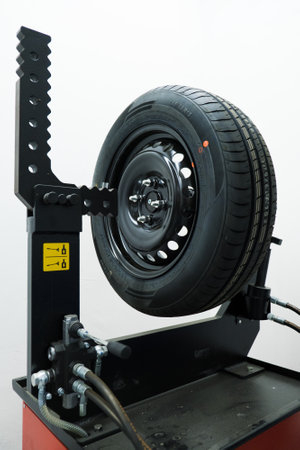 Car tires on the tire fitting machine at service stationの写真素材