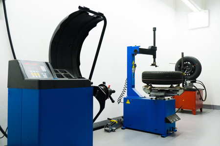 Car tires on the tire fitting machine at service station