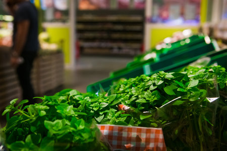 Sale of fresh herbs and other vegetables on the market shelvesの写真素材