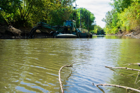 Workers use a dredger when it is necessary to dig the earth from the water