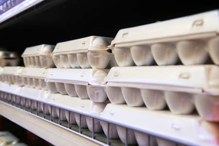 Chicken eggs are sold in containers placed on the shelves of the storeの写真素材