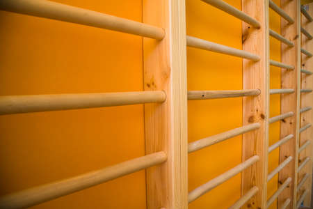 Modern new school building. Empty school gymnasium with yellow floor and climbing near wallsの写真素材