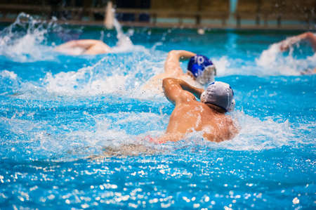 Water polo action in a swimming poolの写真素材