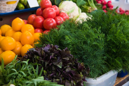 Fresh vegetables are in boxes on the window of a vegetable stallの写真素材