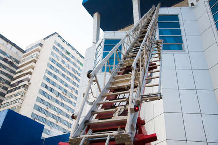 A sliding fire escape is used by emergency services to allow access to the buildingの写真素材