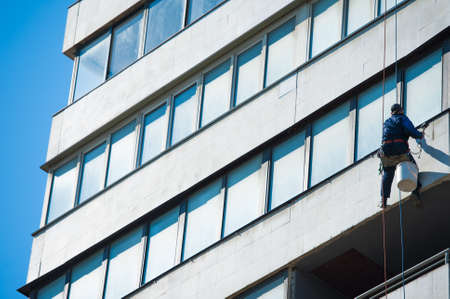 Climbers carry out construction and installation work on the facade of the buildingの写真素材