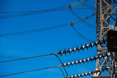 High-voltage power transformer substation. Power plant against a blue sky