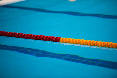 The view of an empty public swimming pool indoors. Lanes of a competition swimming poolの写真素材