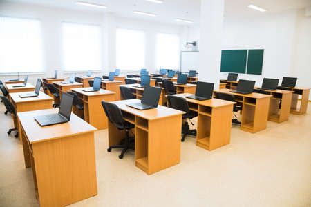 Computer class at school. Laptops on school desks. Distance learningの写真素材