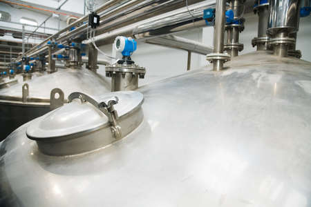 Grain processing facility inside. Industrial factory silos and equipment for food productionの写真素材