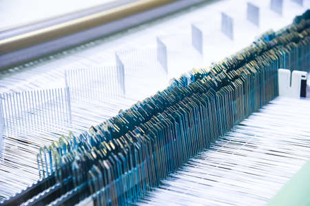 Industrial fabric production line. Weaving looms at a textile factoryの写真素材