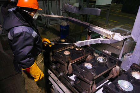 Worker of the foundry of an aluminum plant on an industrial aluminum production lineの写真素材