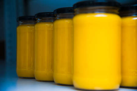 Jars full of organic honey. Production in factoryの写真素材