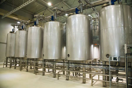 Grain processing facility inside. Industrial factory silos and equipment for food productionの写真素材