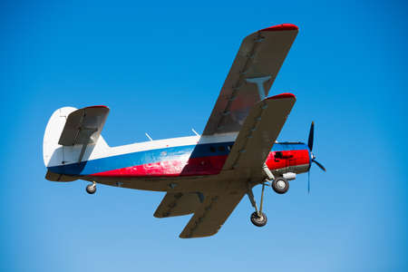 Small aircraft against the blue sky. Flight of an agricultural aviation aircraftの写真素材