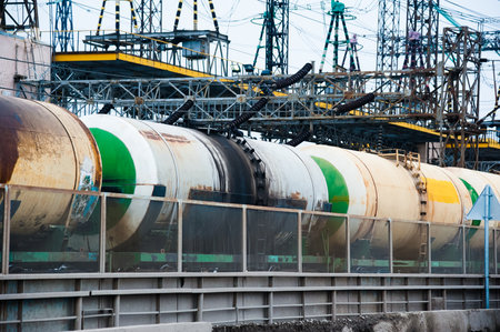 Freight train crossing through railroad station. Railway freight cars and tank carsの写真素材