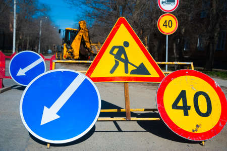 Repair of the old and construction of a new asphalt road. The excavators, graders and road rollers working on the new road construction site.の写真素材