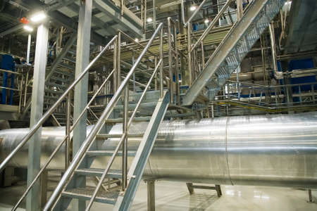 Grain processing facility inside. Industrial factory silos and equipment for food productionの写真素材