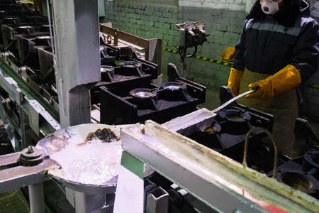 Worker of the foundry of an aluminum plant on an industrial aluminum production lineの写真素材