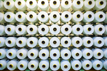 Industrial fabric production line. Weaving looms at a textile factoryの写真素材