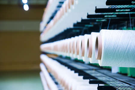 Industrial fabric production line. Weaving looms at a textile factoryの写真素材