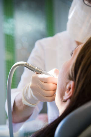 Woman receiving dental treatment. Dental clinic. Dental treatment. Dentist at workの写真素材