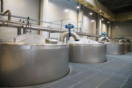 Grain processing facility inside. Industrial factory silos and equipment for food productionの写真素材