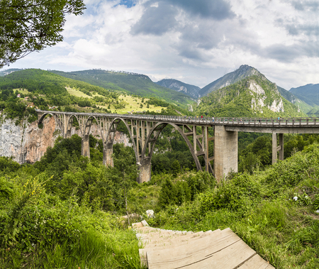 The bridge across the chasm on a Sunny day.の写真素材